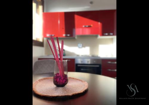 a glass vase with straws sitting on a table at Velluto Suite Apartment in Calderara di Reno