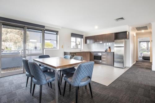 a kitchen and dining room with a table and chairs at Nightelier Doncaster in Doncaster