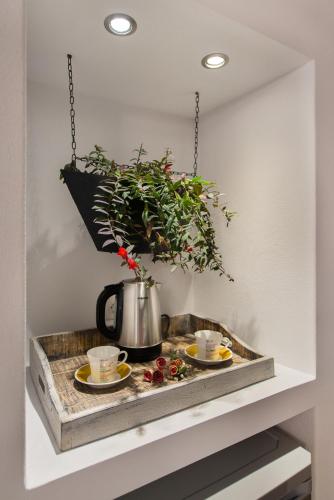 a tray with two cups of coffee and a plant at Lindos Allure Villa with Jacuzzi and Acropolis view!!! in Líndos