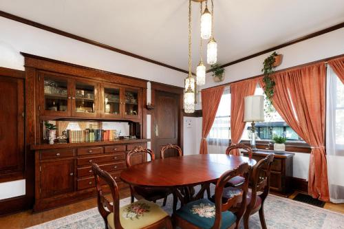 a dining room with a wooden table and chairs at The Betty - A 1920s Vintage Bungalow in Portland