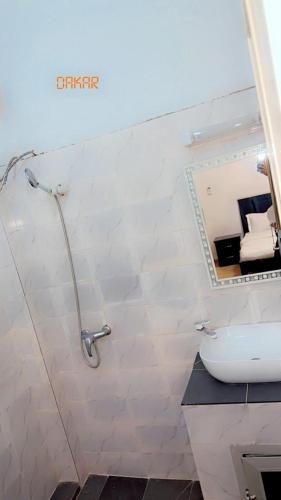 a bathroom with a toilet and a mirror on the wall at Salam in Dakar
