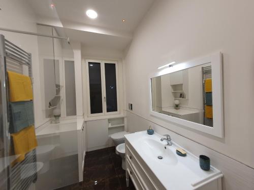 a white bathroom with a sink and a toilet at Casa Menna in Rome