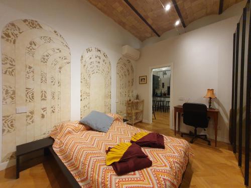 a bedroom with a bed and a desk and a chair at Casa Menna in Rome
