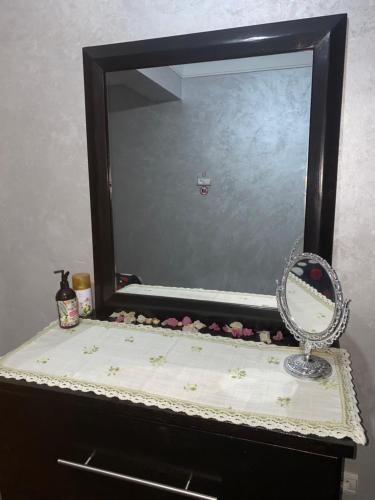 a mirror on top of a dresser with a counter at Appartement de lux in Casablanca