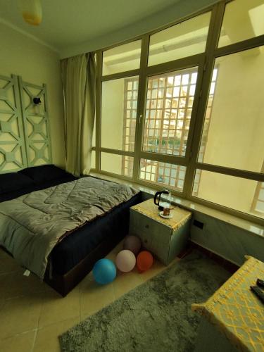 ein Schlafzimmer mit einem Bett und einem großen Fenster in der Unterkunft royal beach resort hurghada in Hurghada