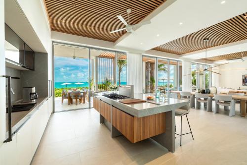 an open kitchen and living room with a view of the ocean at South Bank in Long Bay Hills