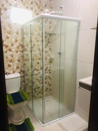 a glass shower in a bathroom with a toilet at Casa Lari milagres in São Miguel dos Milagres