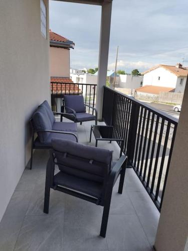 a balcony with two chairs and chairs on a balcony at Joli appartement en Auvergne in Romagnat