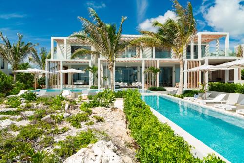 an exterior view of a villa with a swimming pool at South Bank in Long Bay Hills