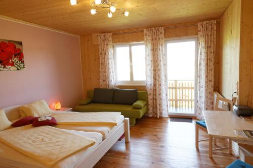 a living room with two beds and a couch at Hildegard Naturhaus in Kirchberg bei Mattighofen