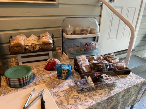 a table with bread and pastries on top of it at The Grand Guesthouse in Key West