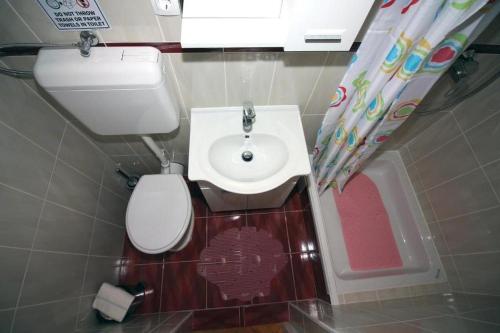 a small bathroom with a toilet and a sink at Apartments by the sea Tisno, Murter - 22006 in Tisno