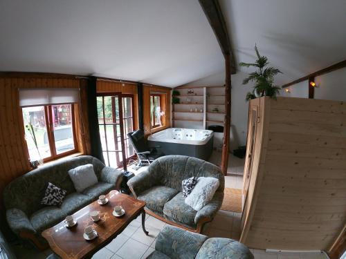 a living room with two couches and a tub at Family friendly house with a parking space Brestova Draga, Gorski kotar - 21977 in Delnice