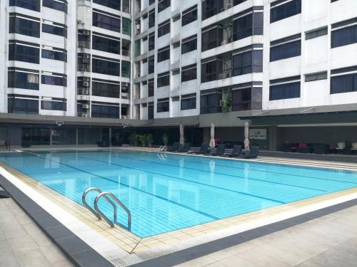a large swimming pool in front of a building at Fahrenheit Pavillion BY JS HomeStay in Kuala Lumpur