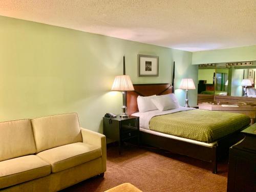 a hotel room with a bed and a couch at Executive Inn Chester in Chester