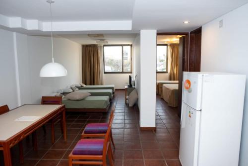 a living room with a couch and a refrigerator at Hotel boutique Tramas Andinas in Salta