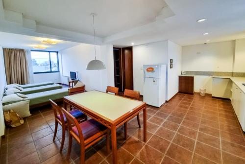 a kitchen and living room with a table and chairs at Hotel boutique Tramas Andinas in Salta