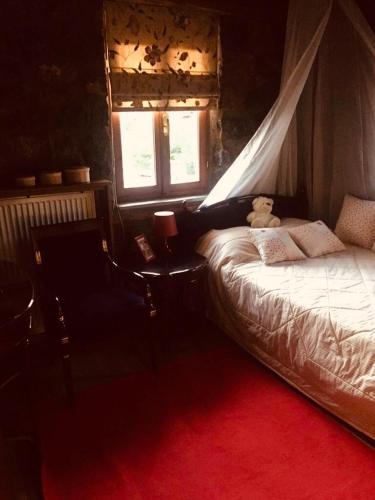a bedroom with a bed with a teddy bear on it at πετρινο σαλε in Palaios Agios Athanasios