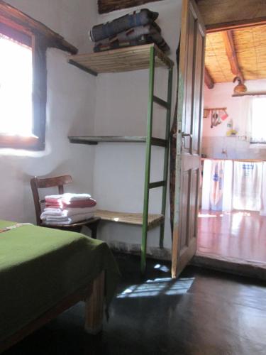 a room with a bunk bed and a ladder at La Calabaza Cabaña in Tilcara