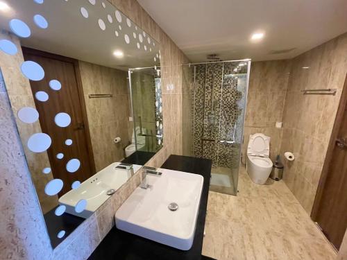 a bathroom with a sink and a tub and a toilet at Large 2 BR Condo, Grand Avenue, Central Pattaya in Pattaya
