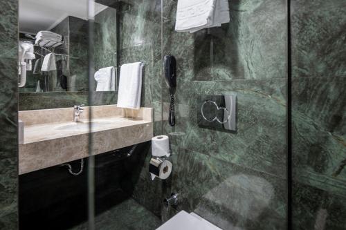 a bathroom with a sink and a shower at Four Points Flex by Sheraton Antalya Lara in Antalya