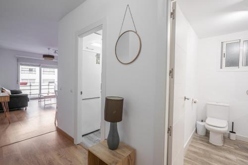 a bathroom with a toilet and a mirror on the wall at Stay U-nique Apartment Ricardo Soriano in Marbella