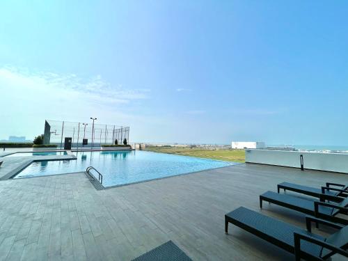 a swimming pool on the roof of a building at Melaka AmberCove Homely Seaview 2R2B in Malacca