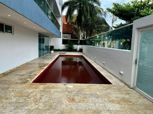 a pool of red water in the middle of a building at Aparta hotel Le Soleil in Cartagena de Indias