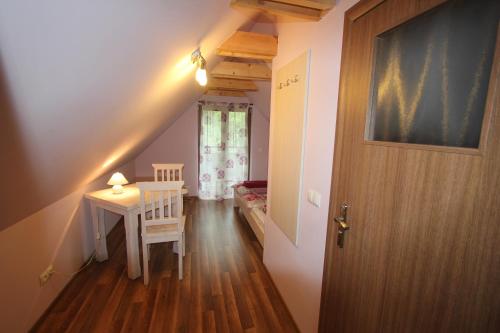 a hallway with a door and a table and a chair at Willa Alicja in Ustroń