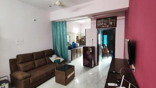 a living room with a couch and a tv at sannidhi homestay 1bhk and 2bhk apartment in Tirupati