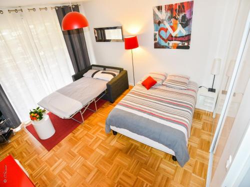 a bedroom with a bed and a table in it at Appartement Monplaisir Part Dieu in Lyon