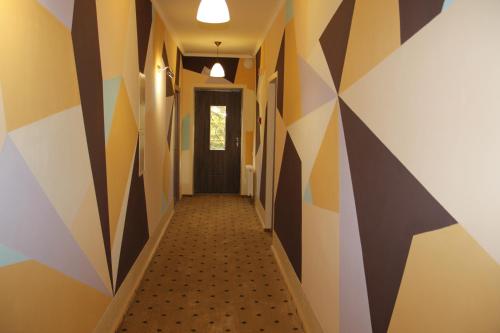 a hallway with geometric patterns on the walls at Mіnі Gotel Pozitiv in Horodets'ke