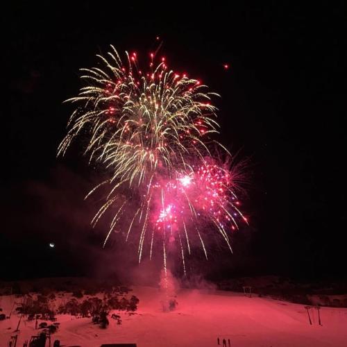 a firework display in the sky at night at Smiggins Hotel & Chalet Apartments in Perisher Valley
