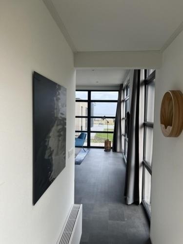 a hallway with a large picture on the wall at Enkhuizer Strand Chalet Meeresbrise Dritte Reihe mit Zaun Haus Nr 251 in Enkhuizen