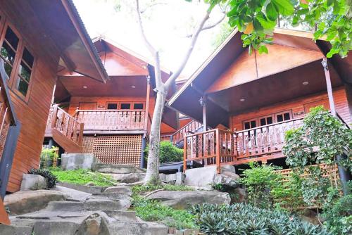 a house with stairs in front of a building at The Cobble Beach Hotel- Phi Phi Island in Phi Phi Don
