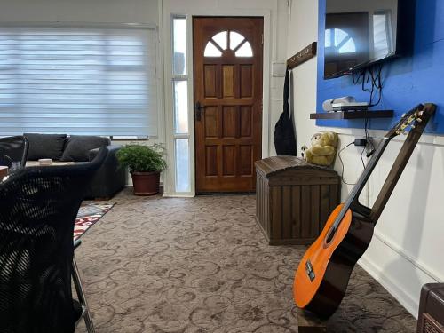 a living room with an orange vacuum in front of a door at Casa in Punta Arenas