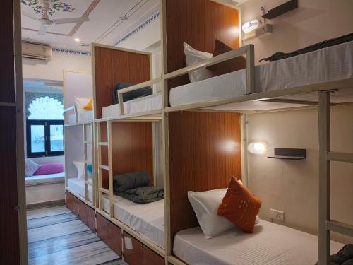 a room with several bunk beds in a room at Madpackers Udaipur in Udaipur