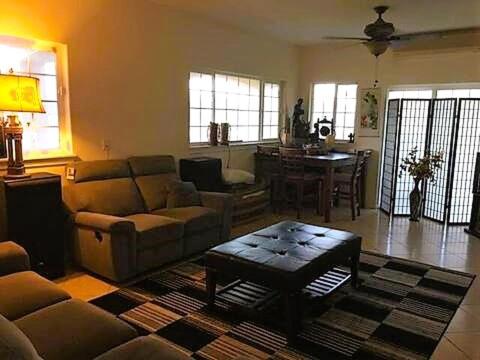 a living room with a couch and a table at Robbins Estate in Wailuku