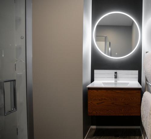 a bathroom with a sink and a mirror at THE Residence Apartment 8 50 Sky in New Plymouth