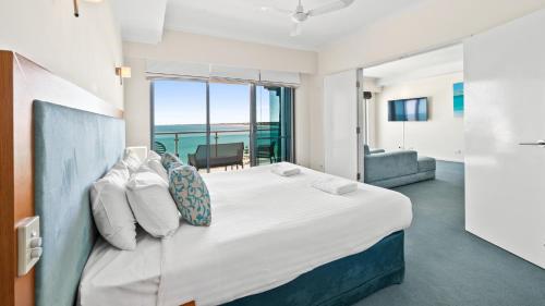 a bedroom with a large bed with a view at Sea Side 508 in Mandurah