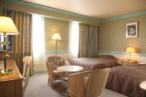Posteľ alebo postele v izbe v ubytovaní Yuzawa Royal hotel