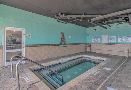 a swimming pool in a room with at Ocean Pearl at Atlantica in Myrtle Beach