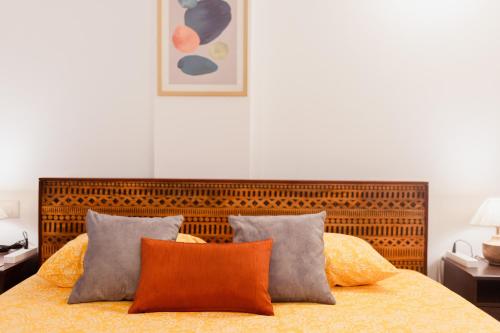 a bedroom with a large bed with two pillows at Luho C 7 in Bangalore