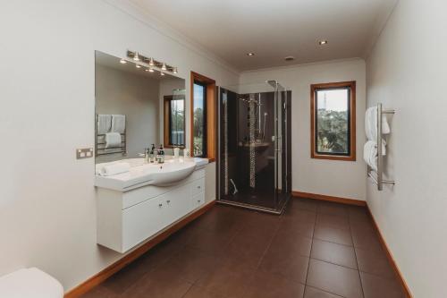 a bathroom with a sink and a shower at Serenity Lodge Getaway in Egmont Village