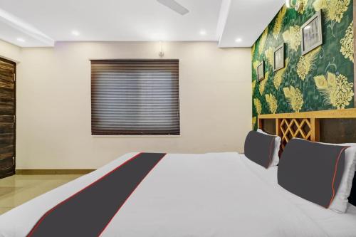 a bedroom with a large bed in a room at Manasi Residency in Bangalore