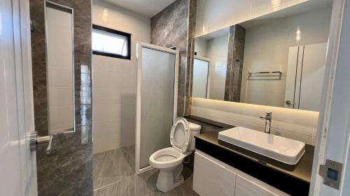 a bathroom with a sink and a toilet and a mirror at Home hug luxury house in Nan