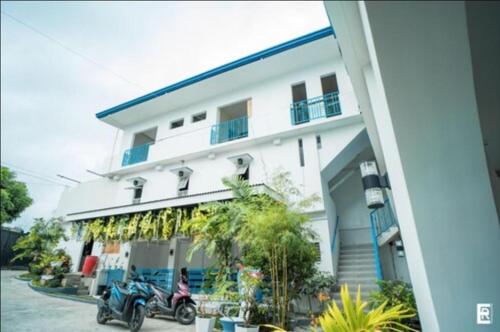 a motorcycle parked in front of a building at Bernese Resort Hotel powered by Cocotel in Ligao