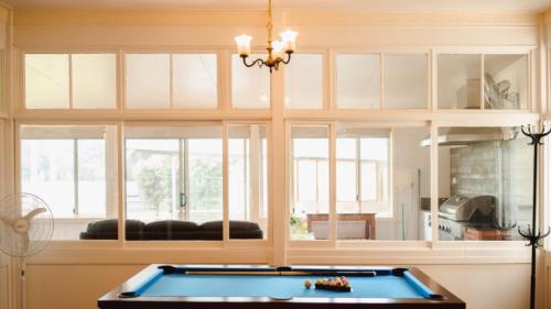 a kitchen with a pool table in a room at Riverfront Retreat - Sussex House Holiday Park in Sussex inlet