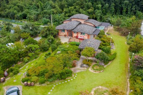 an aerial view of a house with a garden at Songjukheon Pension in Damyang