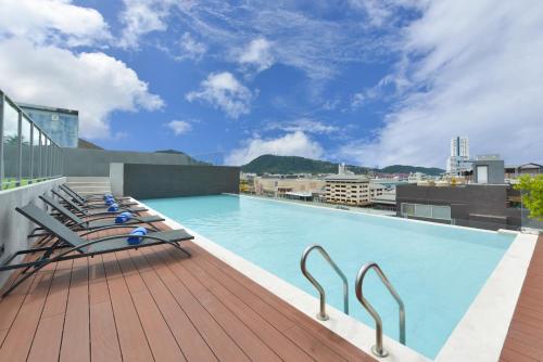 a large swimming pool on the roof of a building at Grace Patong Hotel in Patong Beach